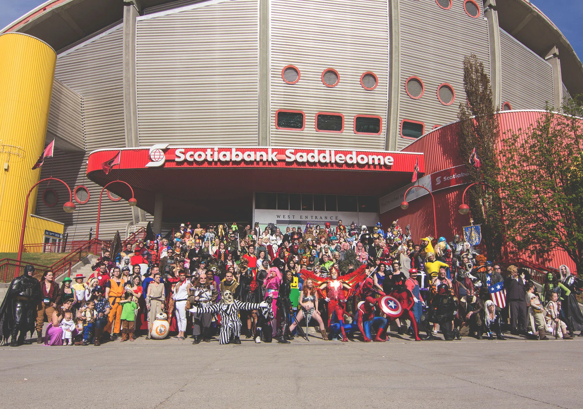 group of Calgary Expo attendees in cosplay posing for a photo outside of Scotiabank Saddledome