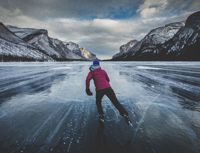 Woman skating on Lake Louise in winter