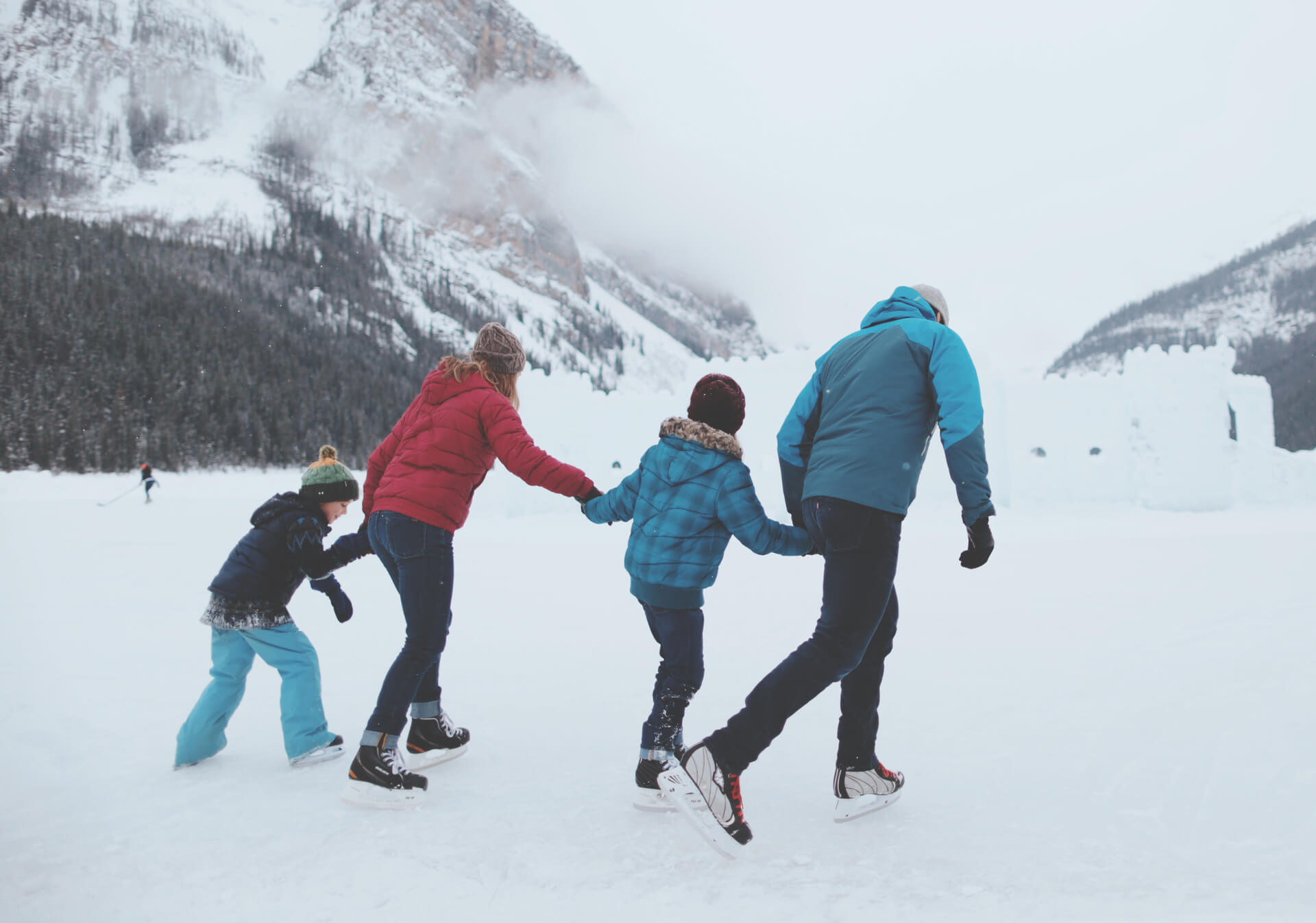 Family Ice skating on lake louise