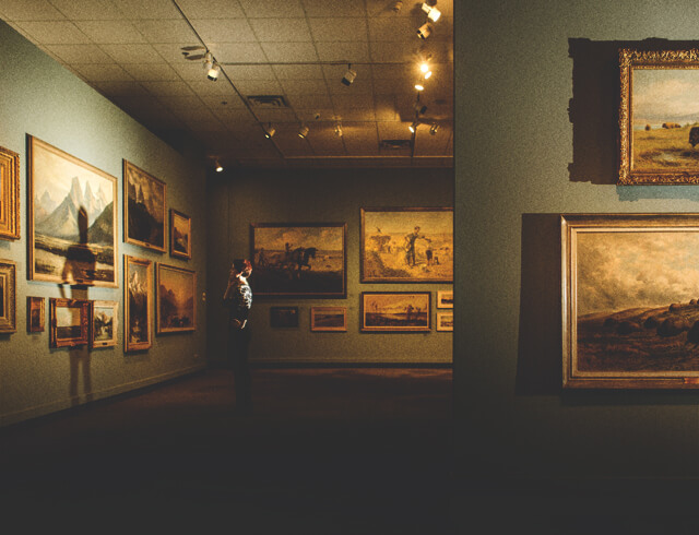 Browsing a gallery of paintings at the Glenbow Museum