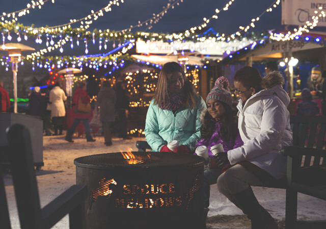 Warm up by the fire at the Spruce Meadows International Christmas Market