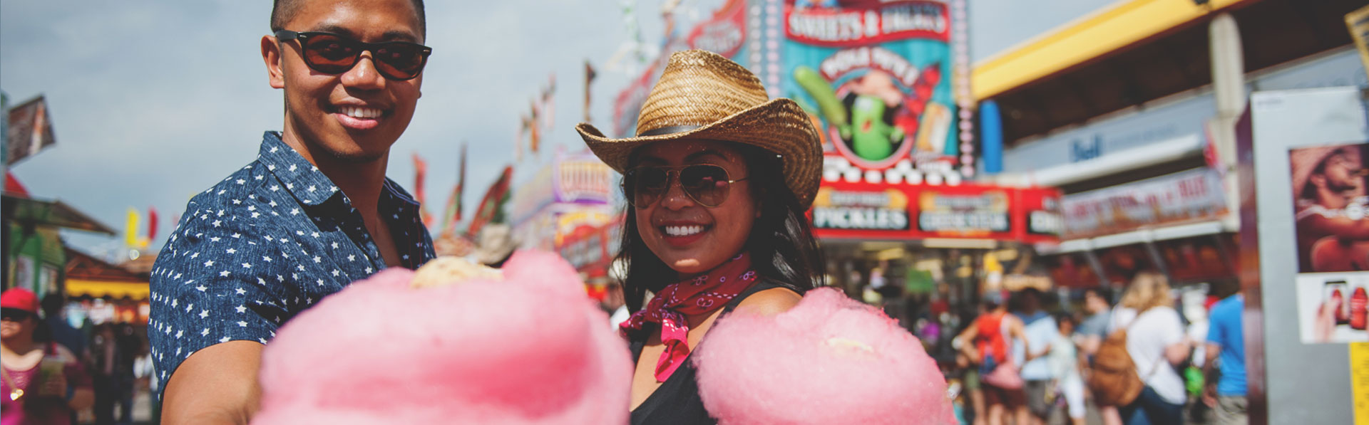 Couple enjoying cotton candy in the Calgary Stampede midway