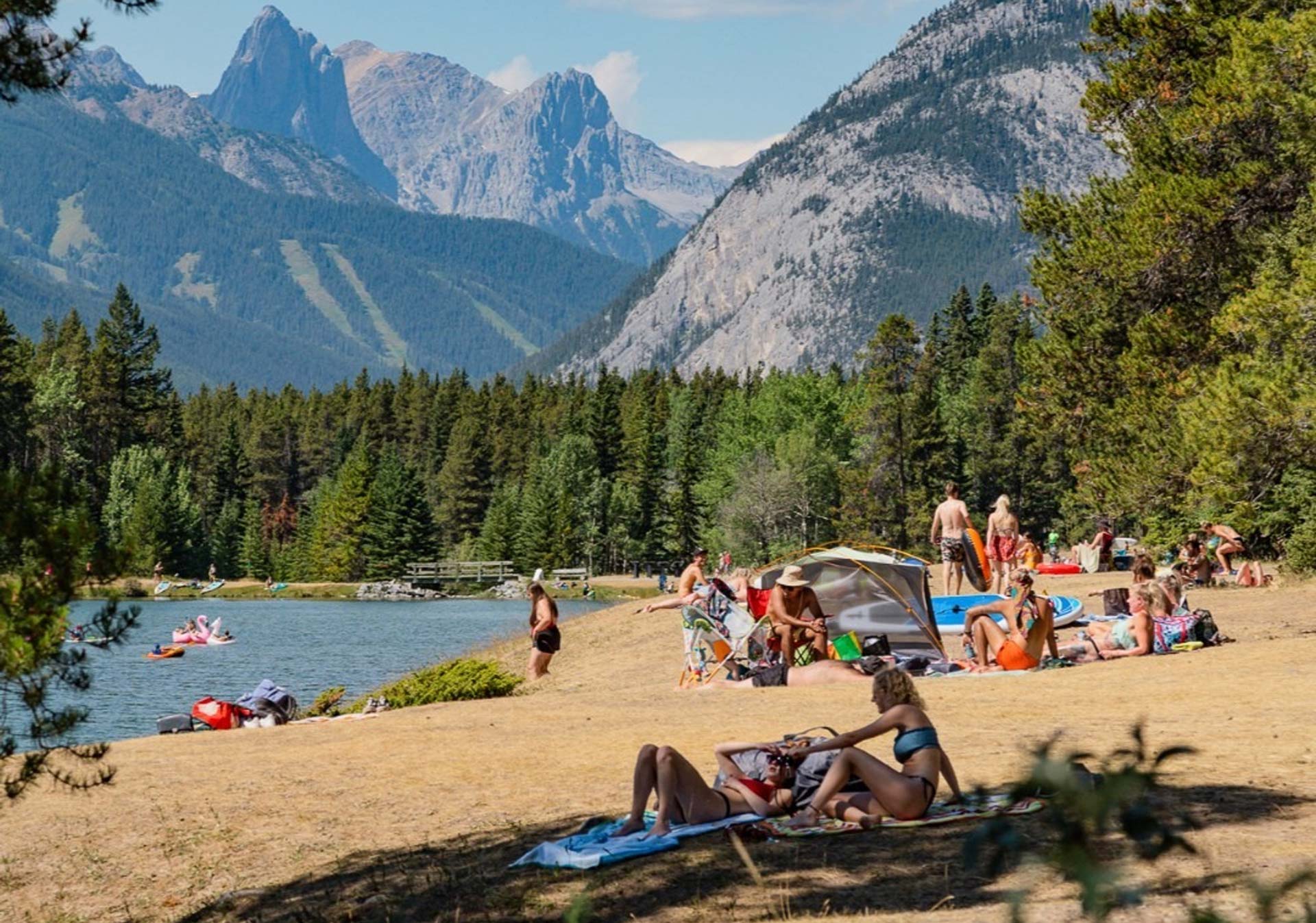 People hanging out on the beach at Johnson Lake, Banff