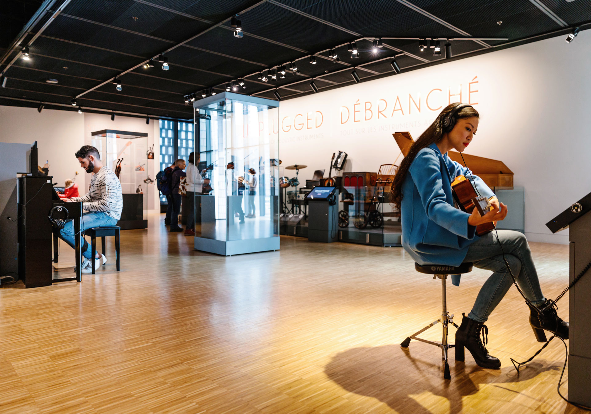 Two people playing music at Studio Bell, home of the National Music Centre.