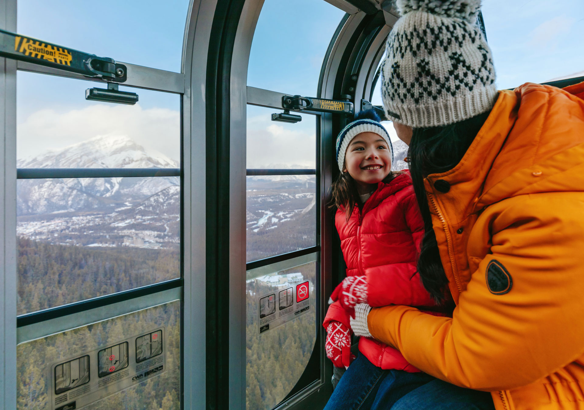 Mother and child riding the Banff Gondola