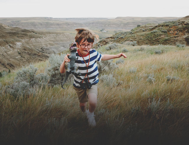 Child looking for dinosaurs in the Alberta Badlands