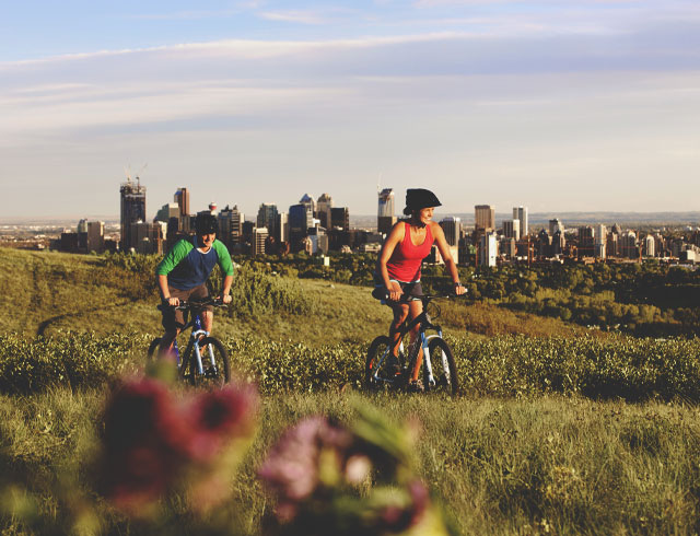 Biking on Nose Hill with the Calgary skyline in the background