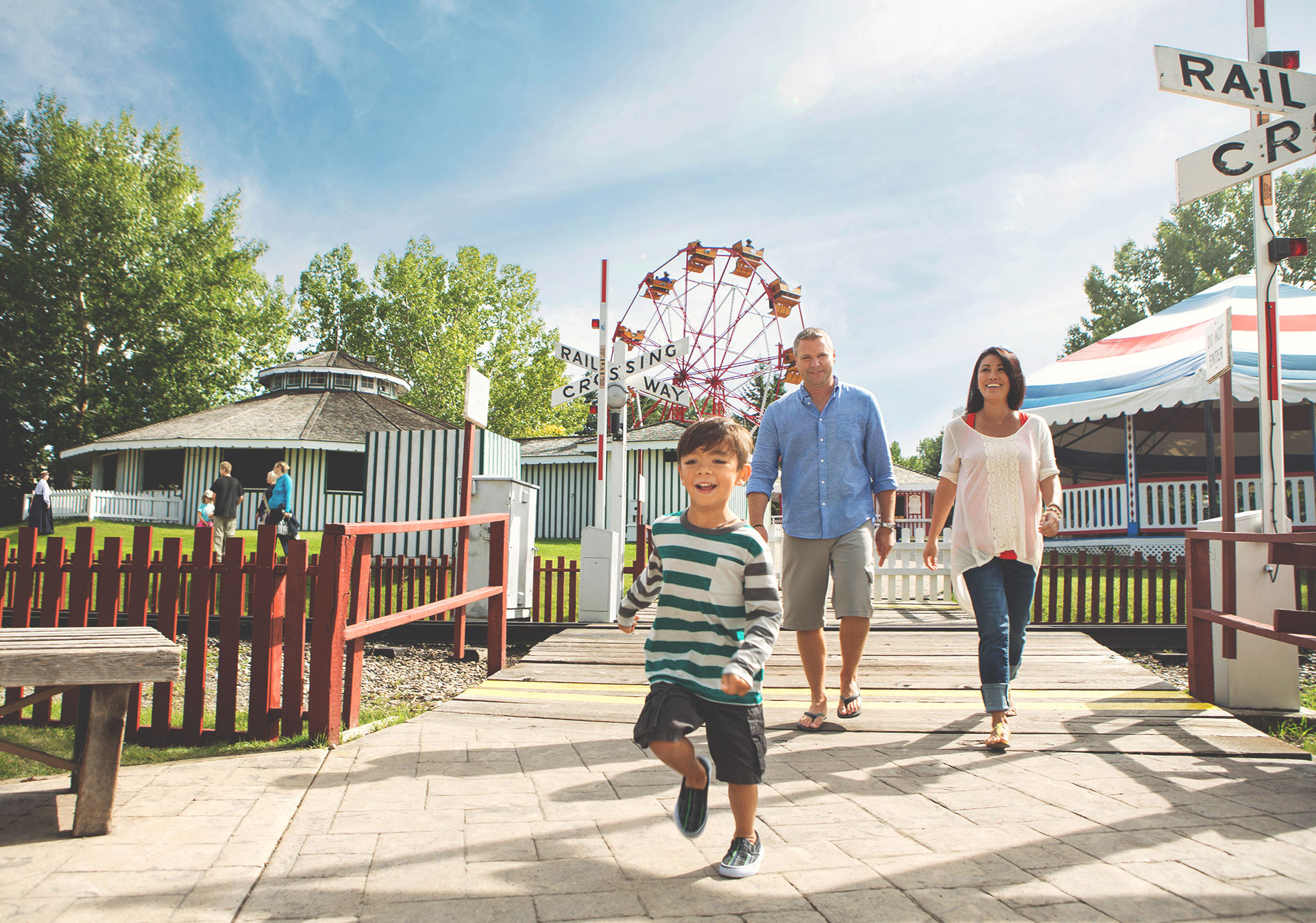 Family in front of Ferris Wheel at Heritage Park