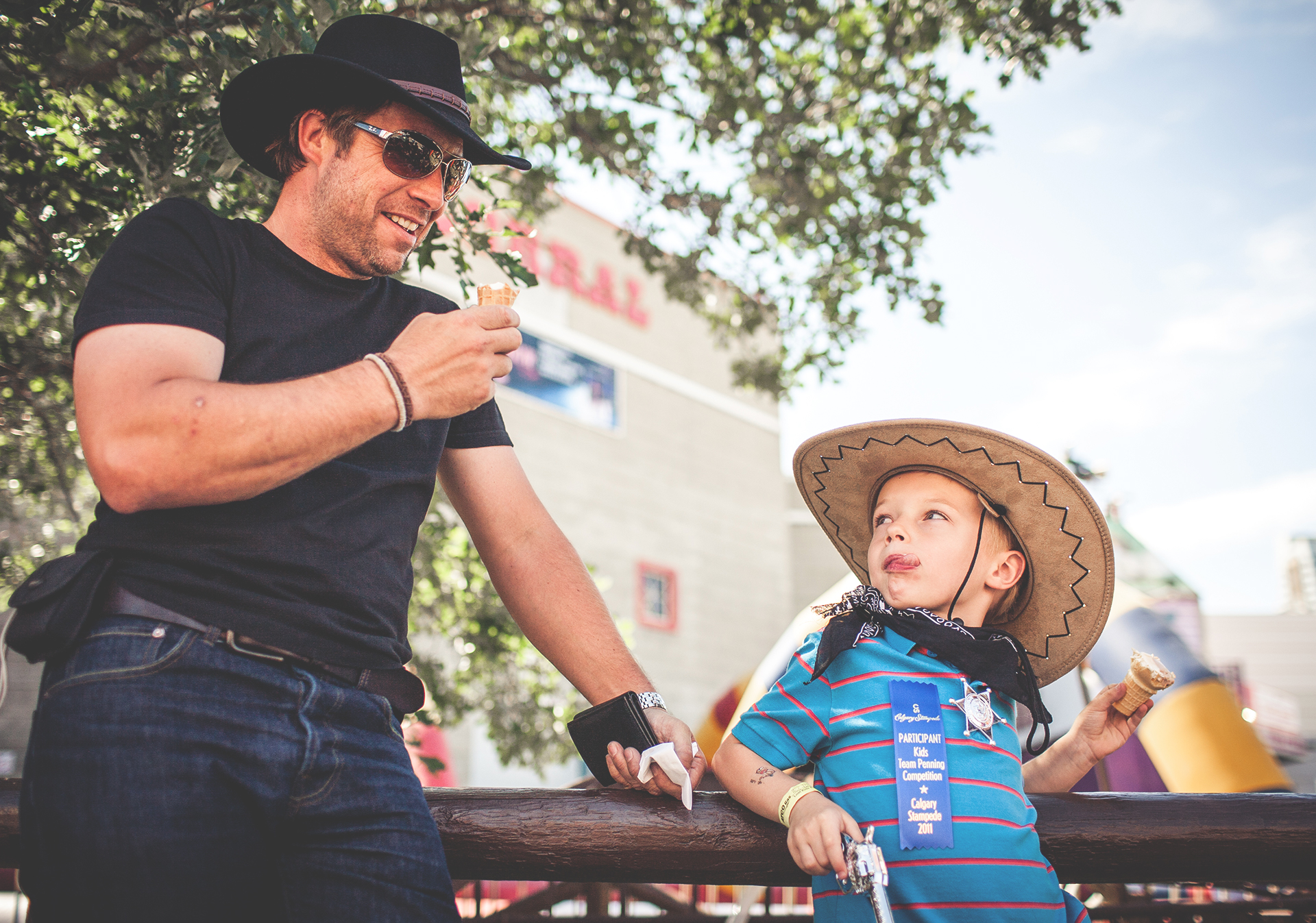 Father and son sharing ice cream at the Calgary Stampede