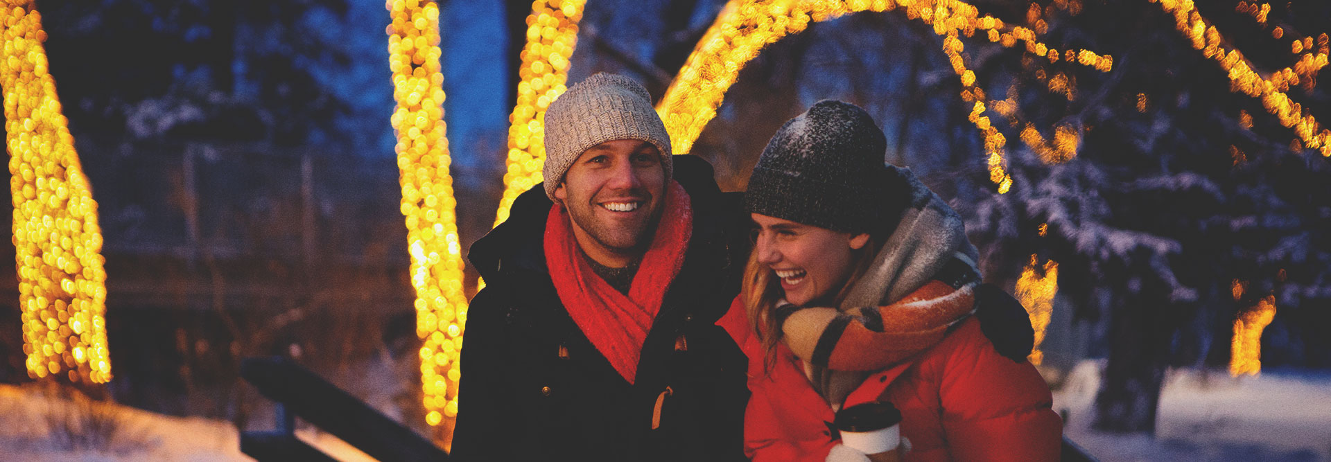 Couple sitting by an outdoor fire in winter
