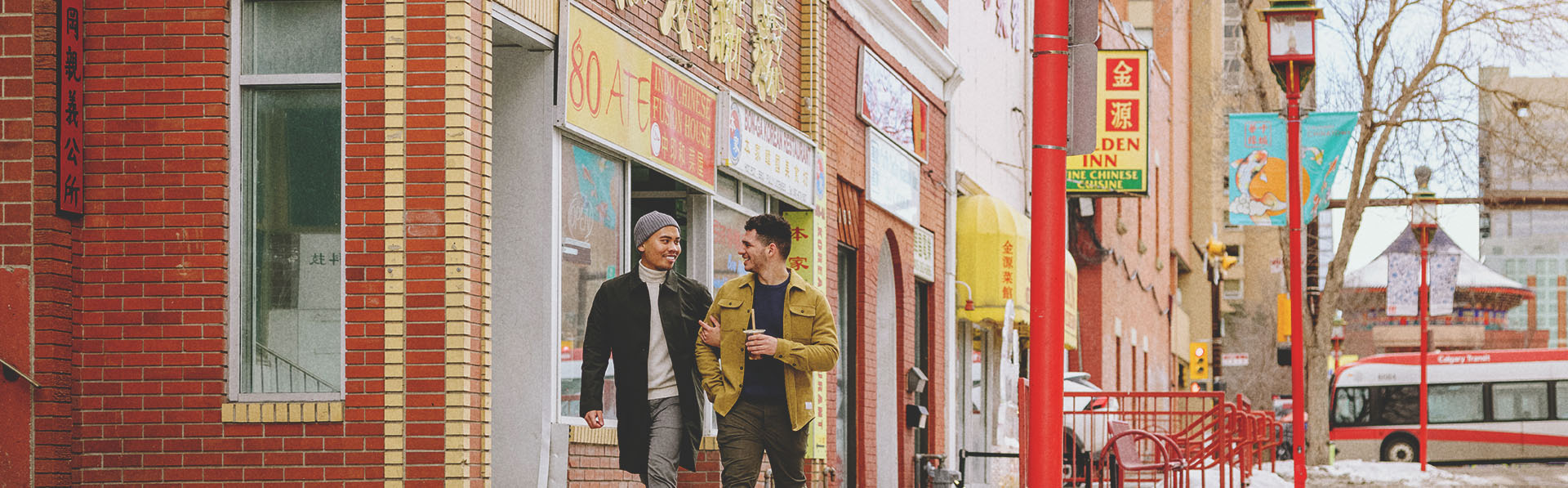 Couple walking through Calgary's Chinatown in winter