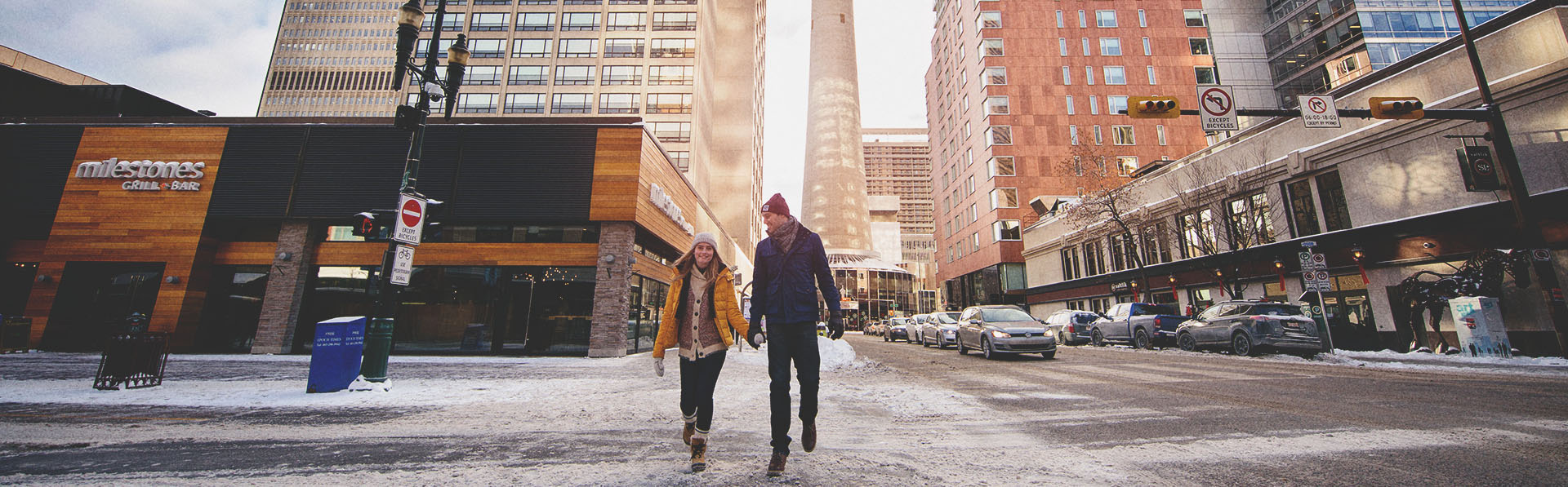Couple walking along Stephen Avenue in winter