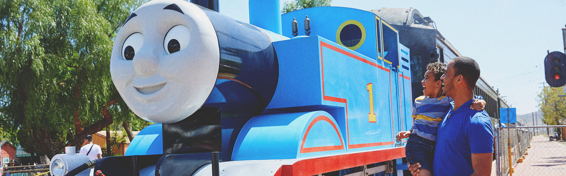father & son posing with Thomas the Engine at Heritage Park