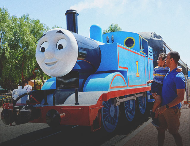 father & son posing with Thomas the Engine at Heritage Park