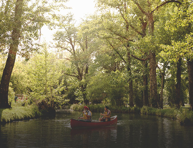 Father and son canoeing through Bowness Park