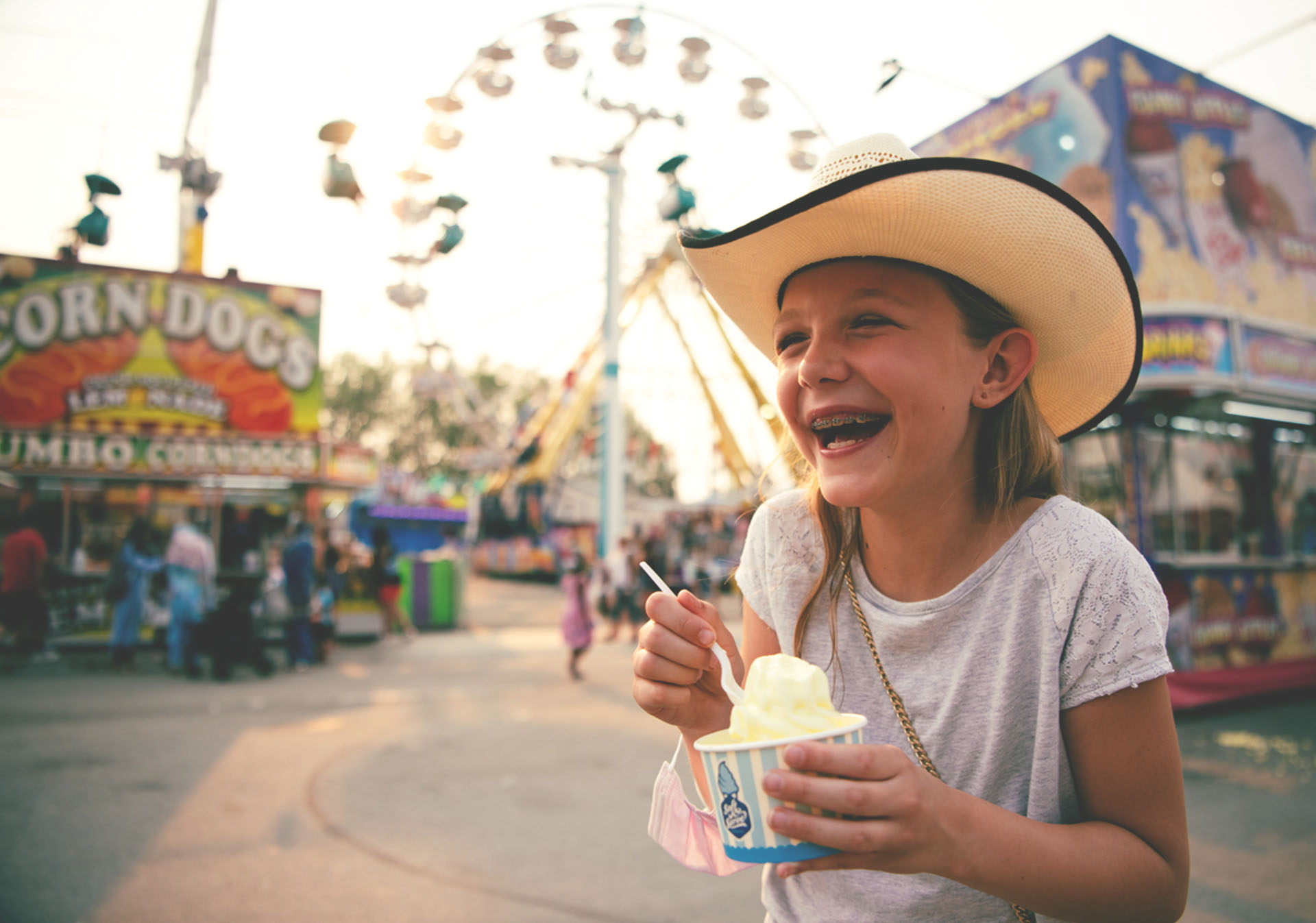Young girl eating ice cream at the Stampede midway