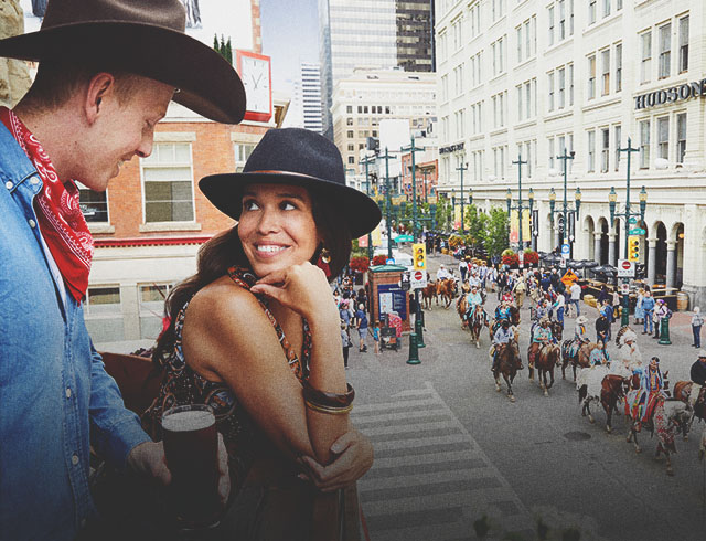 couple watching the Stampede Parade from a balcony on Stephen Ave