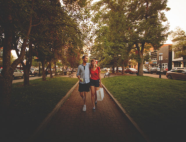 couple walking through Tomkins Park on 17th Avenue