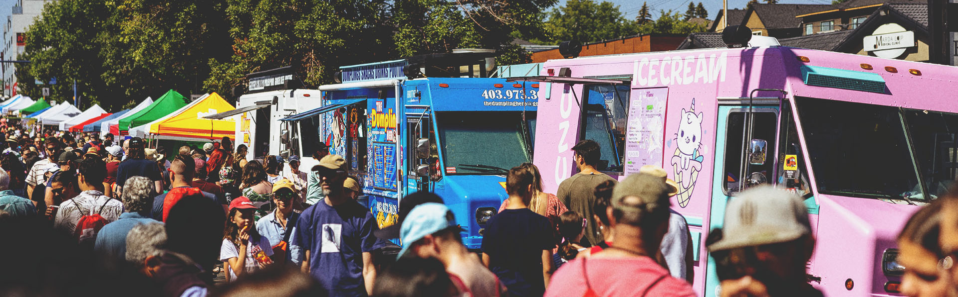 crowds of people ordering from food trucks at Marda Gras Street Festival