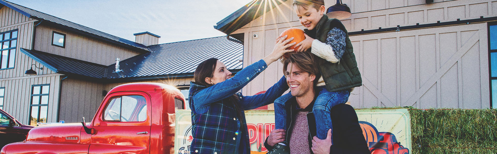 family in the pumpkin patch at Granary Road during autumn