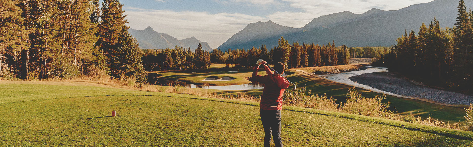 Golfer swinging at Kananaskis Golf Course