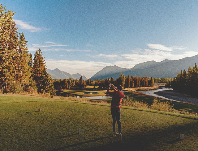 Golfer swinging at Kananaskis Golf Course