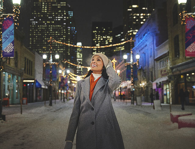 woman walking along Stephen Avenue in downtown Calgary during winter