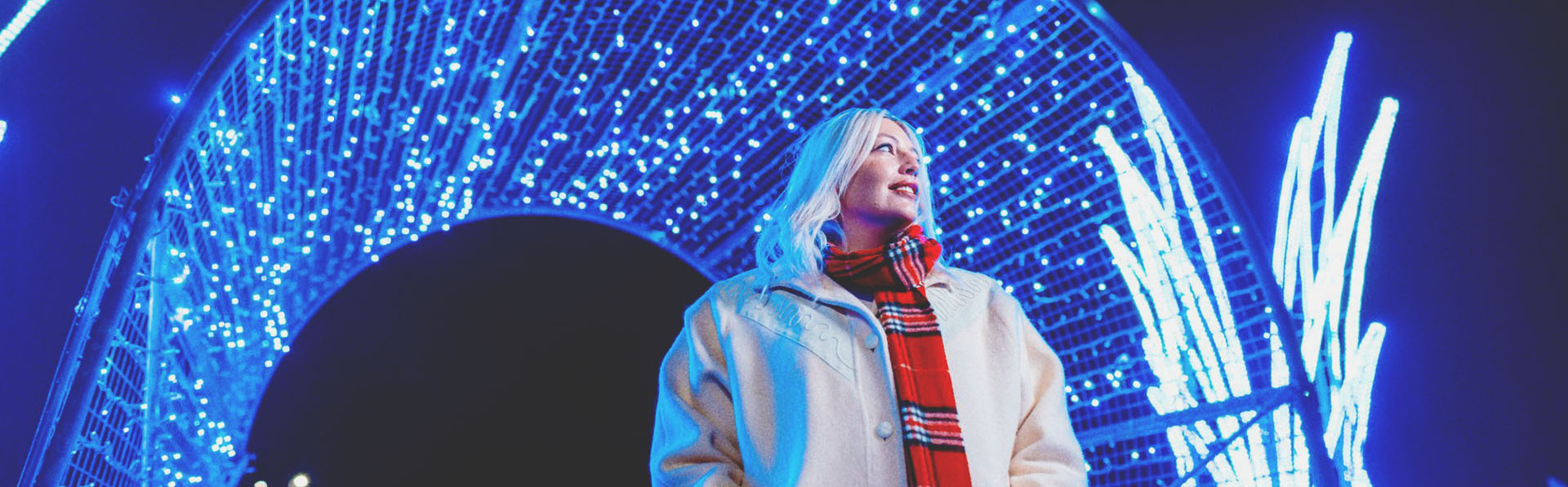 woman exploring the holiday light displays at ZOOLIGHTS