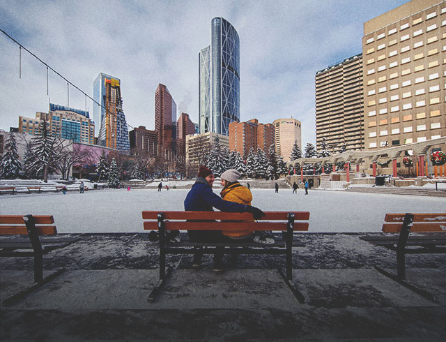 couple takes a break from skating on a bench in Calgary's Olympic Plaza downtown