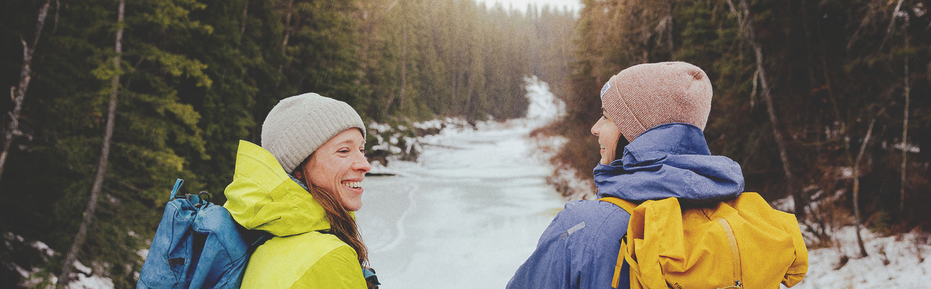 Two ladies hiking through Fish Creek Park during winter