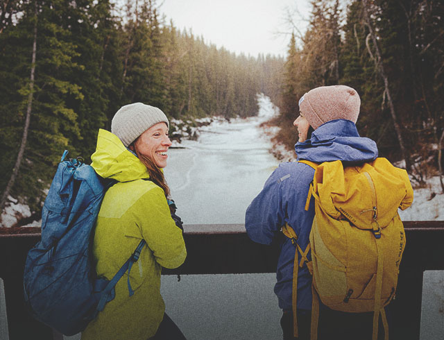 Two ladies hiking through Fish Creek Park during winter