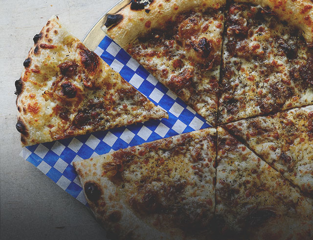 pizza with a slice removed from Pizza Face in Calgary