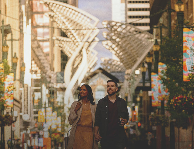 couple walking along Stephen Avenue during summer