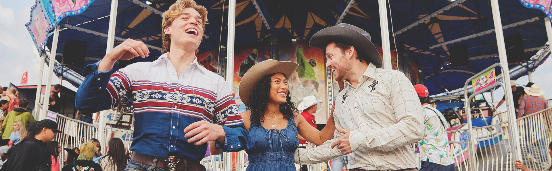 three friends exploring the Calgary Stampede midway
