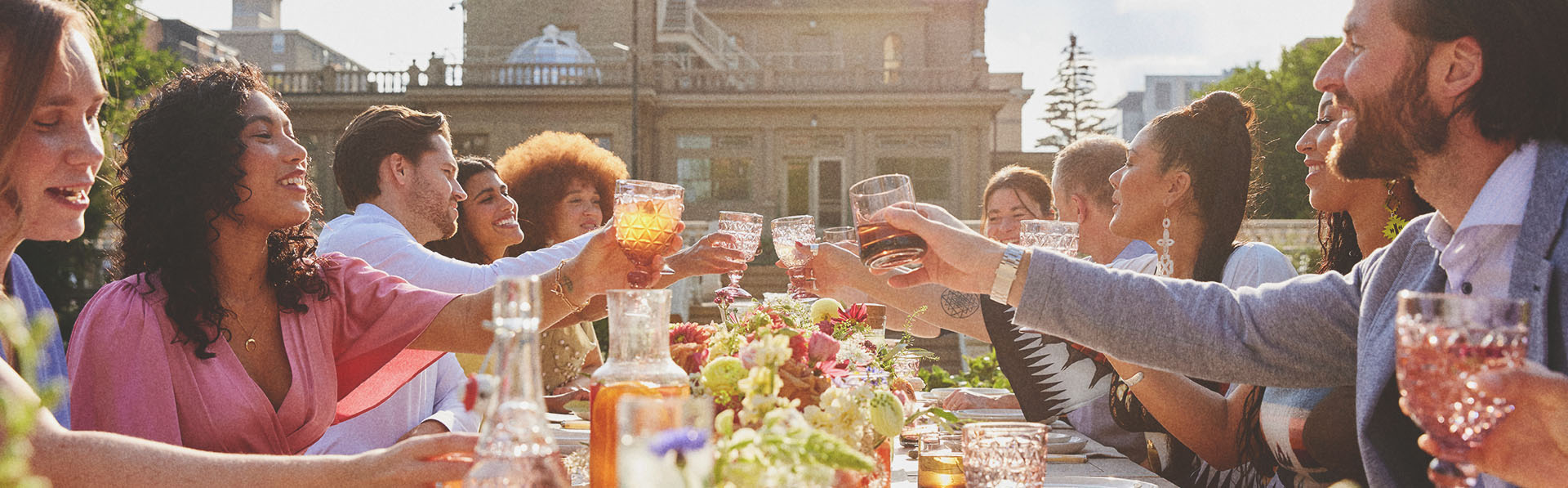 group dining at a long table during a private event held at Lougheed House during spring