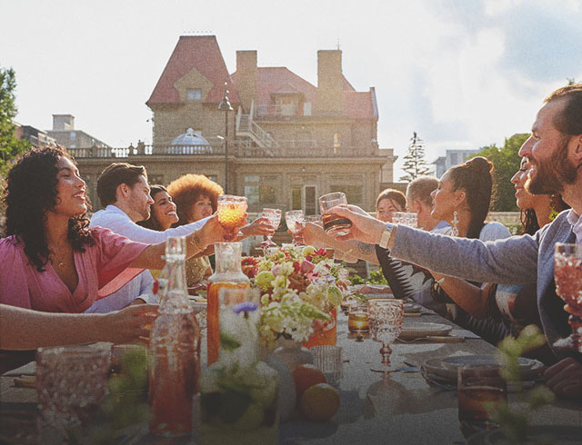 group dining at a long table during a private event held at Lougheed House during spring
