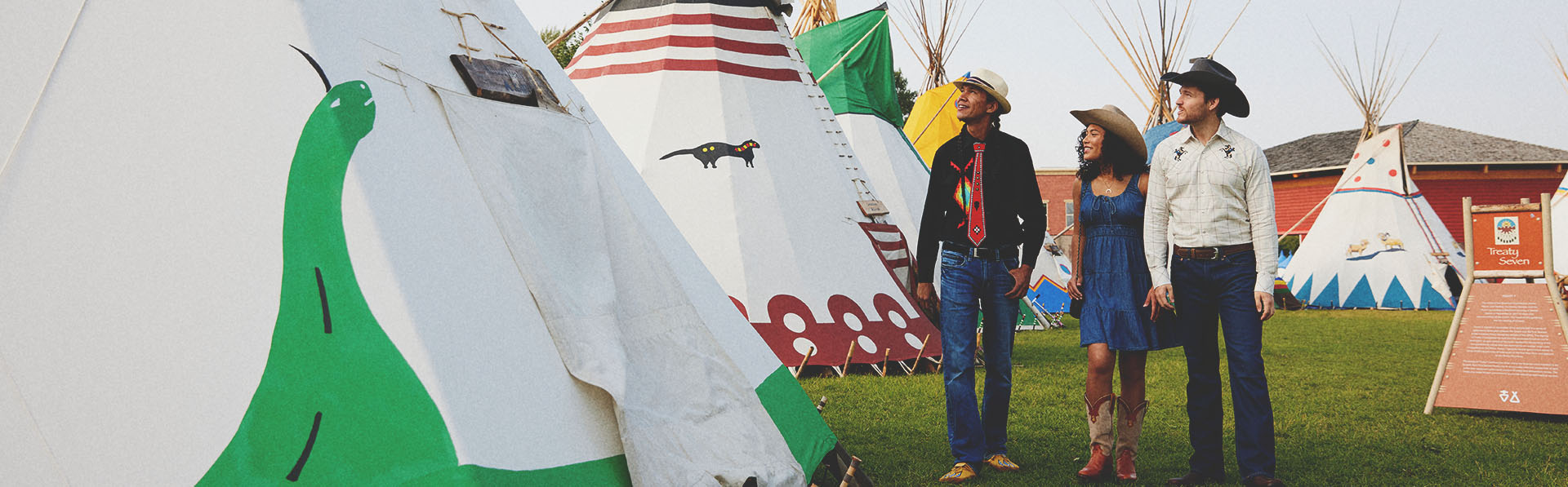 couple taking a tour of Elbow River Indigenous Camp on the Calgary Stampede Grounds