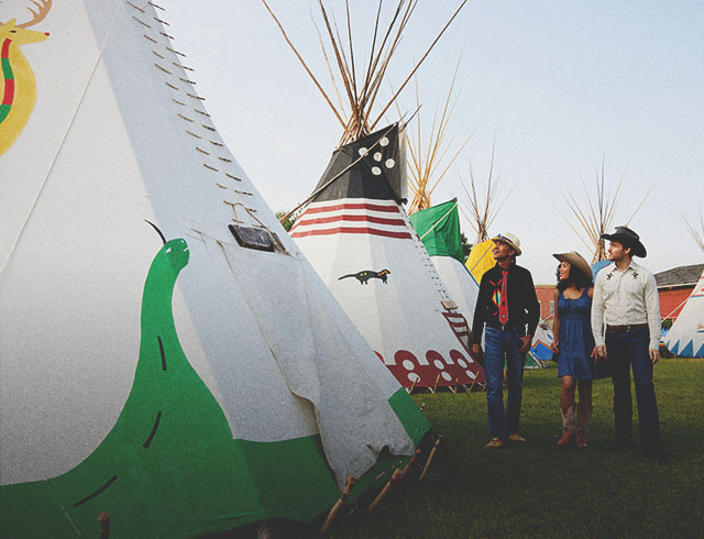 couple taking a tour of Elbow River Indigenous Camp on the Calgary Stampede Grounds