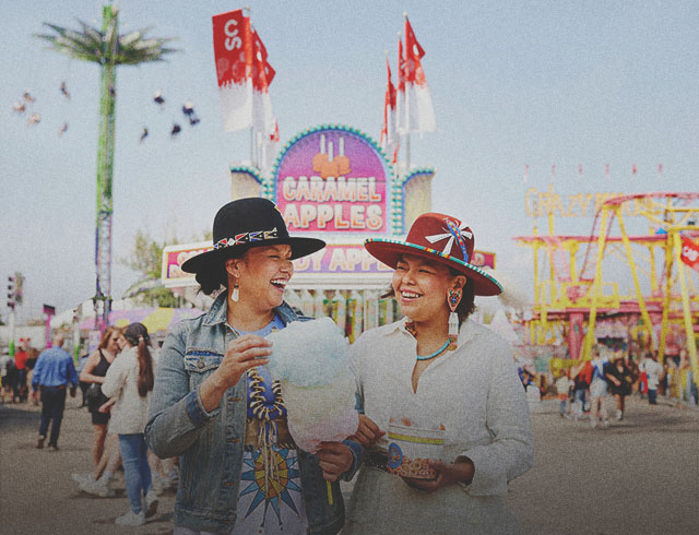two Indigenous ladies enjoying some classic midway food at Calgary Stampede