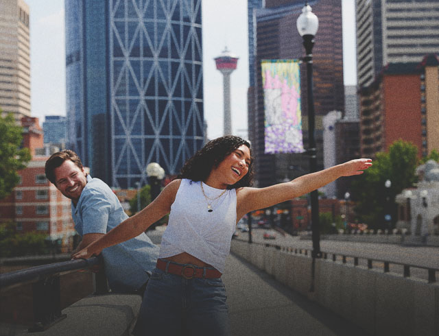 couple walking along centre street bridge during summer