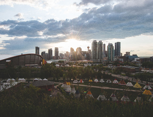 Elbow River Camp at Calgary Stampede with the Calgary skyline in the background