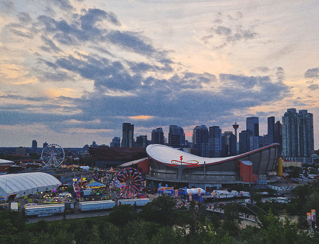 the Stampede Grounds with the Calgary skyline in the background at dusk