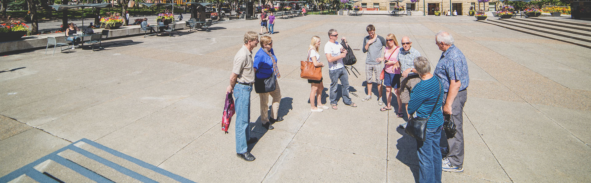 A group on a guided walking tour throughout downtown Calgary