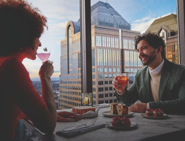 couple dining at Major Tom beside panoramic skyline views