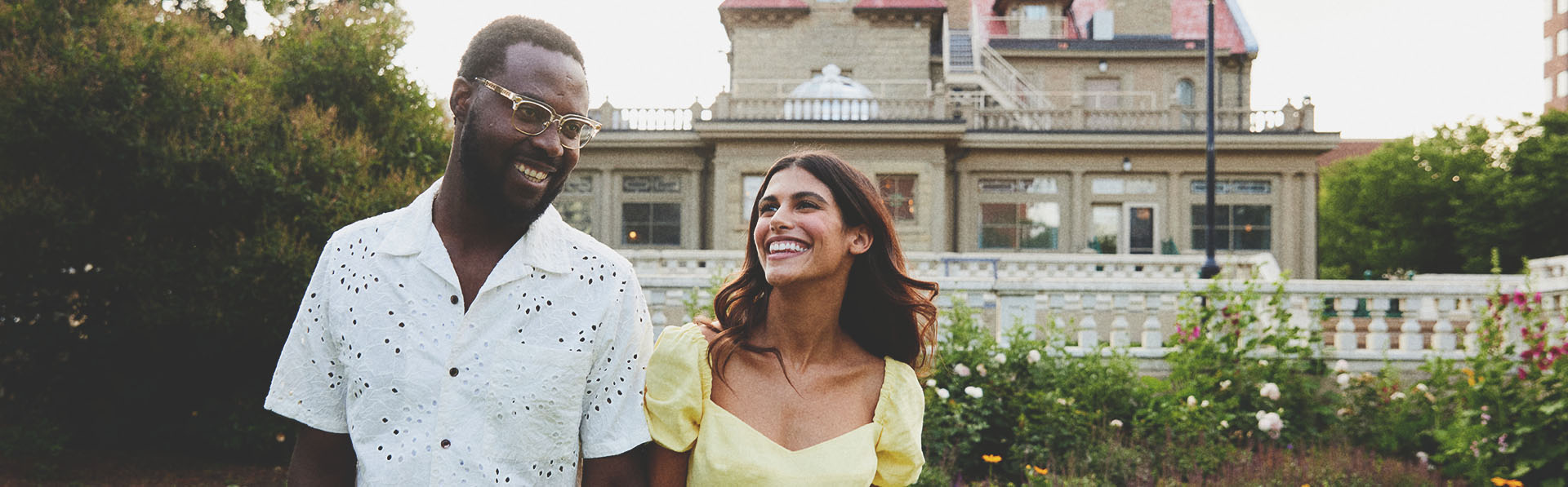 couple smiling in front of the Lougheed House