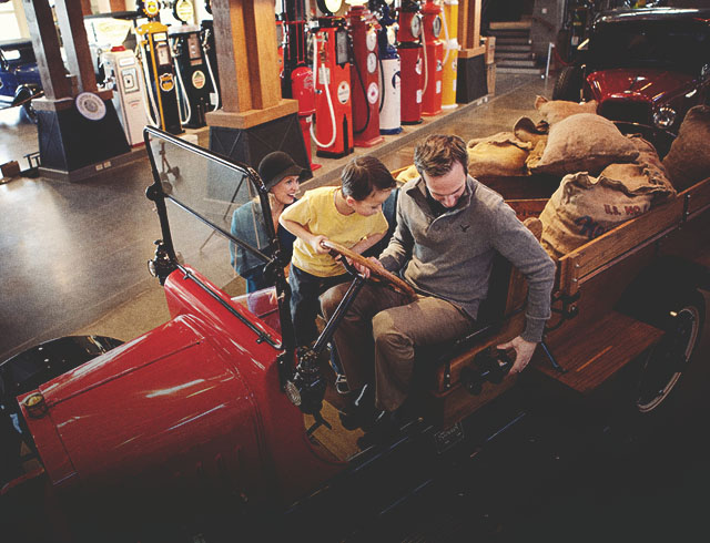 family experiencing a car at the Gasoline Alley Museum Heritage Park