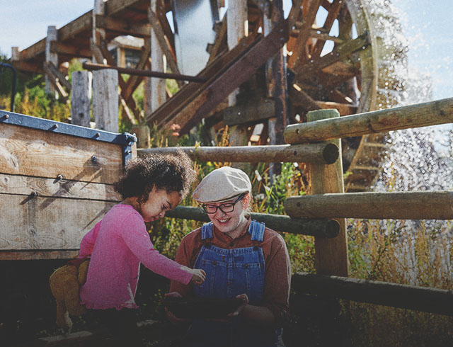 a kid and a lady experiencing gold panning at Heritage Park