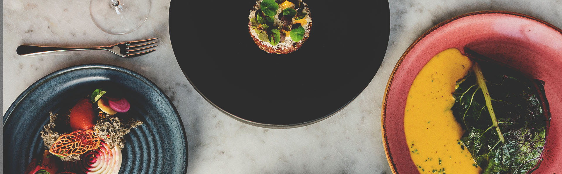 Table with dishes of food at The Wilde on 27