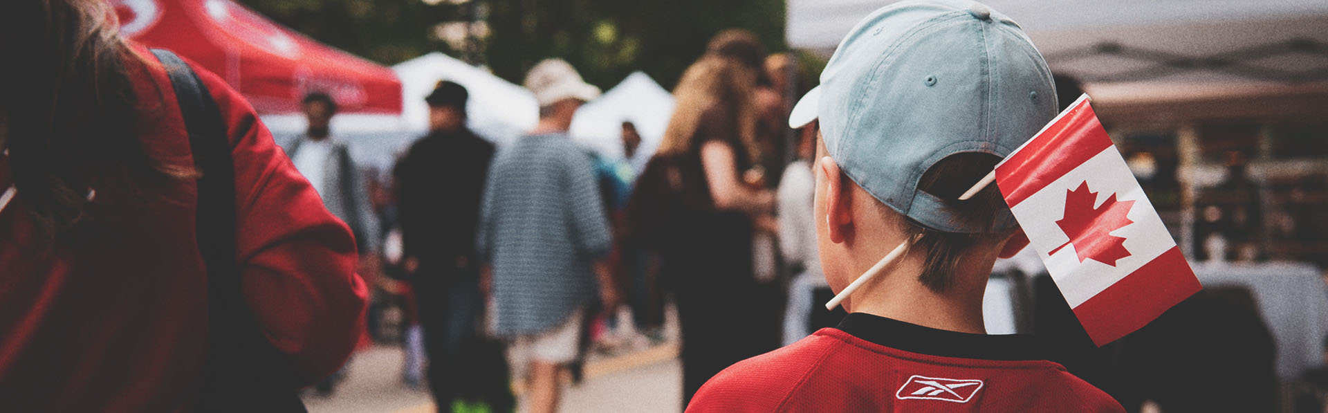 A little boy with a Canadian flag celebrating Canada Day