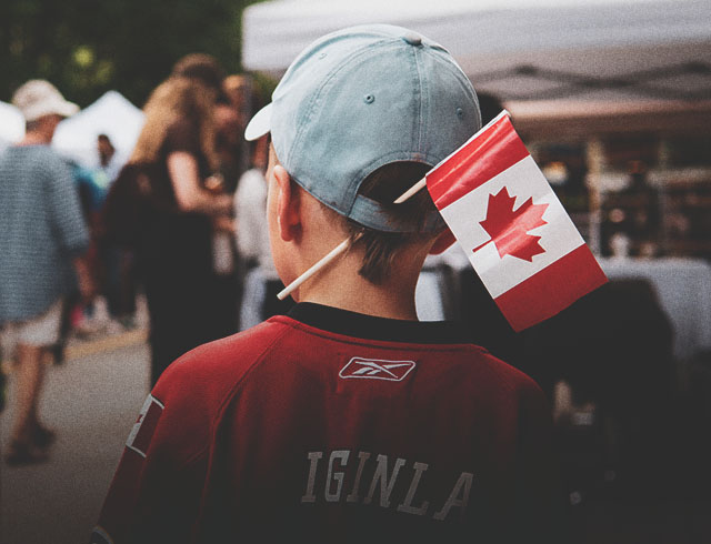 A little boy with a Canadian flag celebrating Canada Day